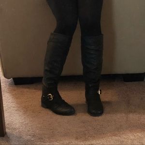 Black boots with gold buckle